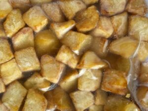 Frozen fried sweet potato dice in a clear bag