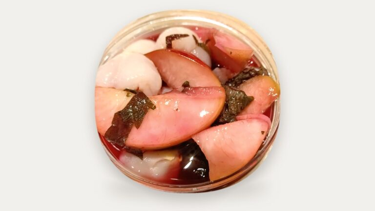 Frozen Perilla Peach: peach slices and perilla (shiso) leaves in red peach juice in a clear jar