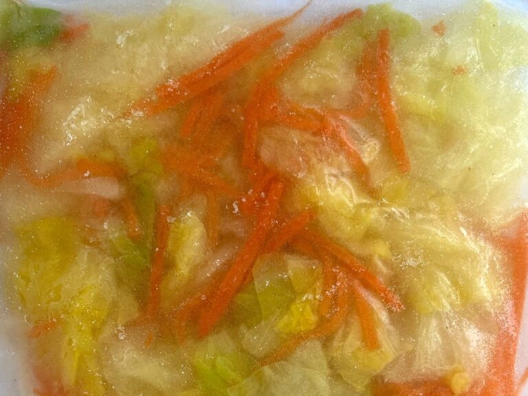 Frozen seasoned kohlrabi and shredded carrot in a vacuum-sealed bag