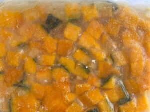 Frozen seasoned pumpkin dice in a vacuum-sealed bag