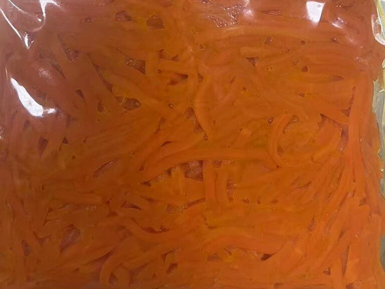 Frozen seasoned shredded carrot in a vacuum-sealed bag