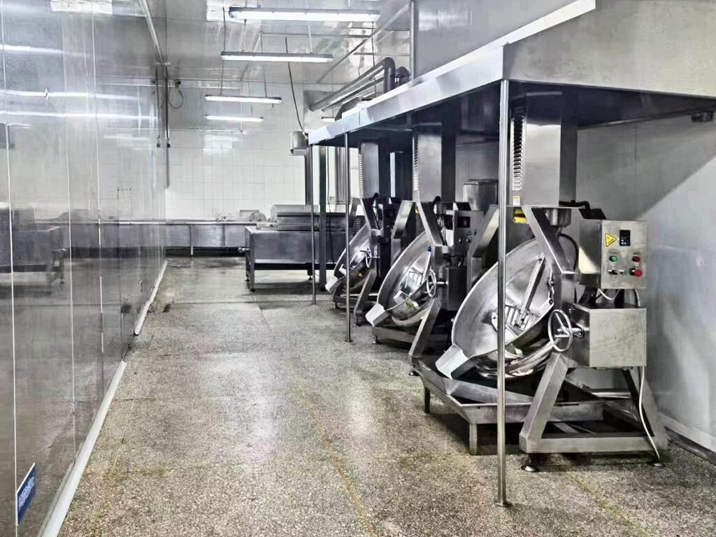Cooking kettle room with a row of jacketed kettles